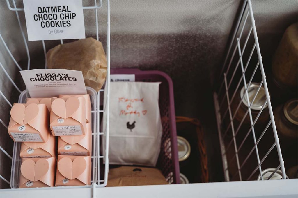 Close up of the inside of the freezer at the farmstand with Elissa’s Chocolates, cookies, and jars of soup