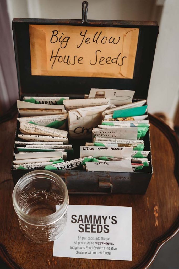 close up of Sammy’s Seed packets squished into a metal box.